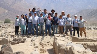 A group of archaeologists standing in the desert