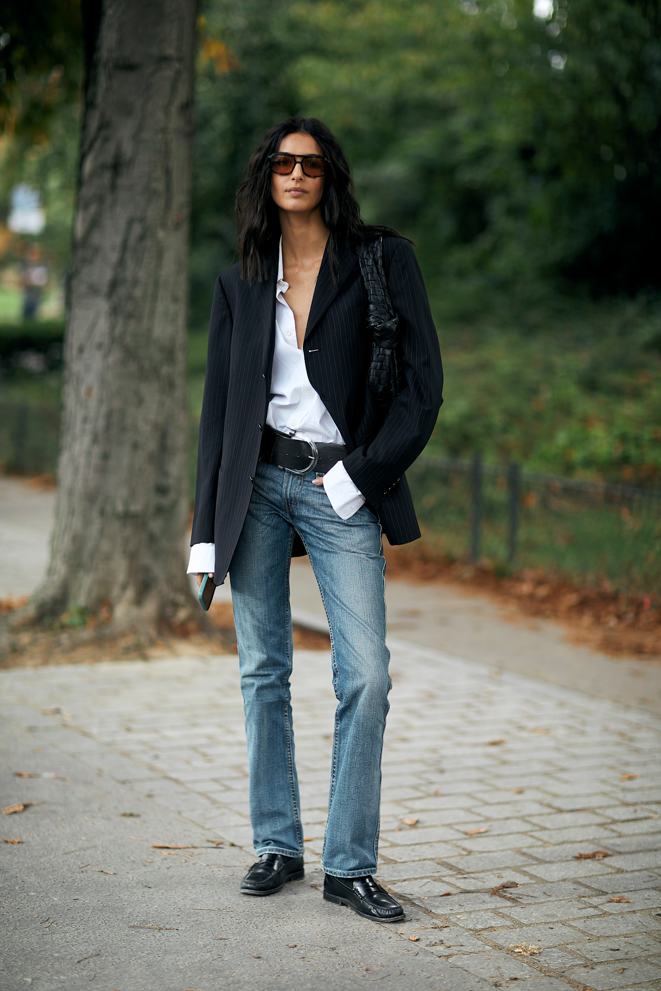woman wearing cigarette jeans, a blazer, a button-down, and loafers