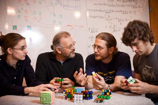 Team led by Erik Demaine figuring out the mathmatics of the Rubik's cube. From left to right, Sarah Eisenstat, Martin Demaine, Erik Demaine and Andrew Winslow.