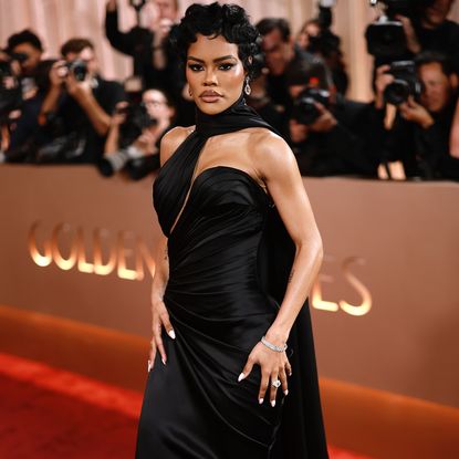 Teyana Taylor at the Golden Globes red carpet. She is wearing a black gown, a pixie hairstyle, and edgy eye makeup.