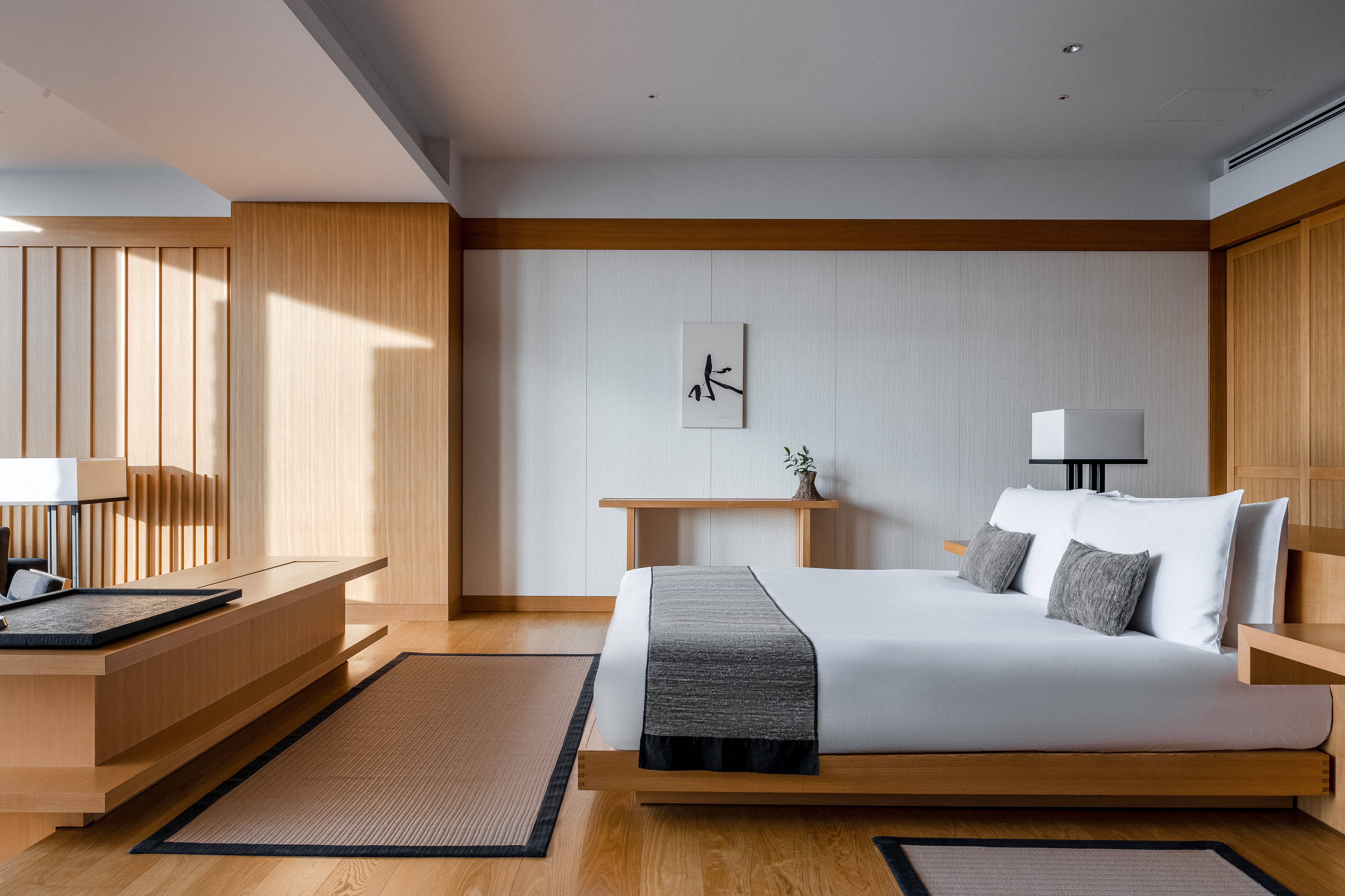 view of a serene hotel in tokyo, adorned with wooden furnishing, washi paper and natural stone touches