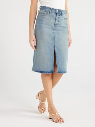 Model wears denim midi skirt in a light wash with tan-colored heeled sandals