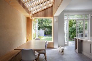 a modern extension with a timber side return, and open windows and doors out to the garden