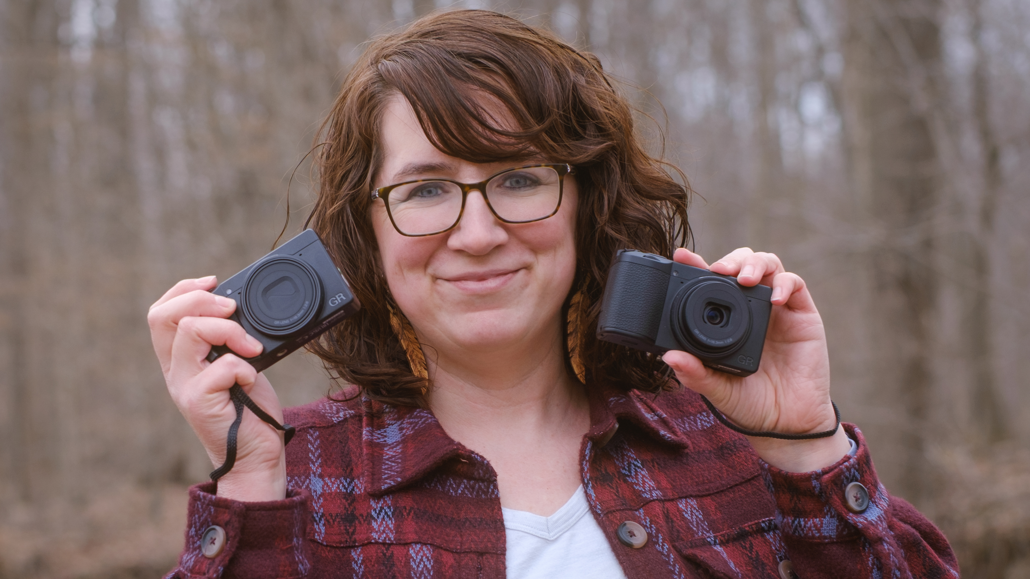 Hillary Grigonis holding Ricoh GR IV HDF and GR IV Monochrome compact cameras