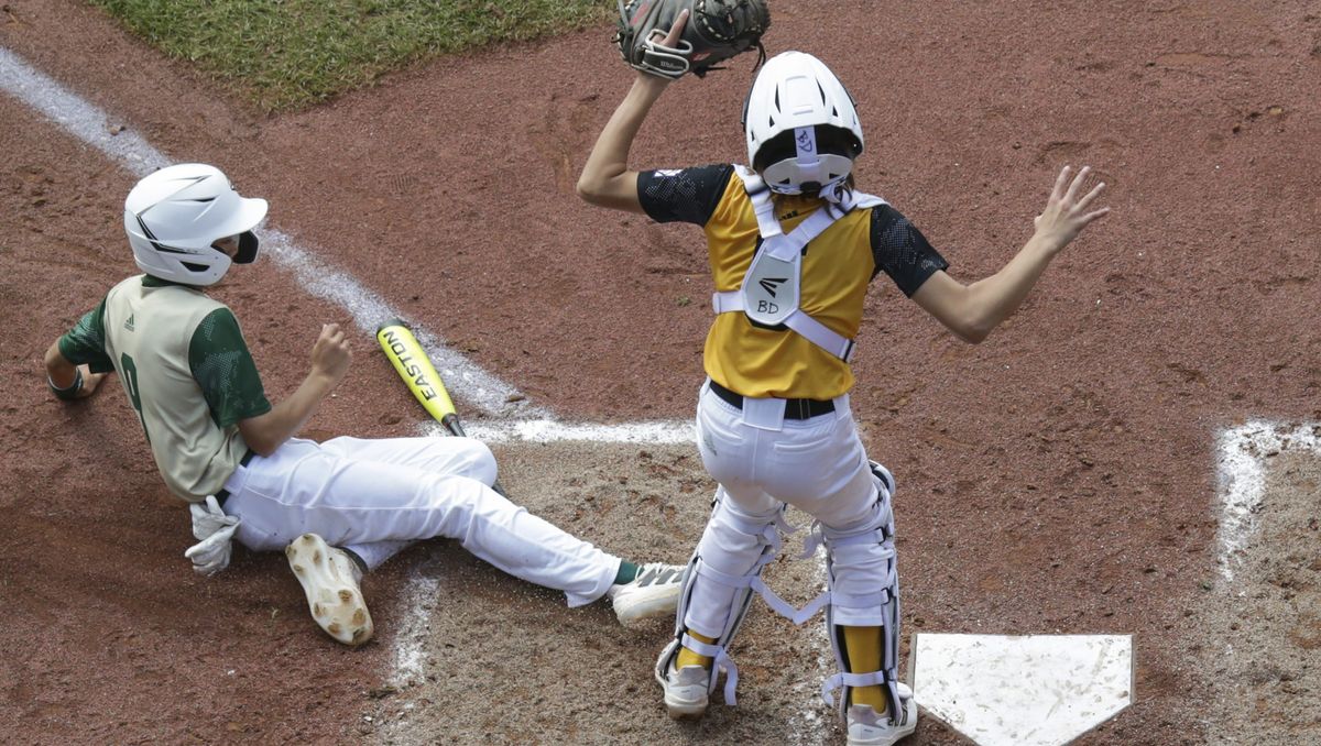 Li Fang-Mo #9 of the Asia-Pacific Region team from Taipei City, Chinese Taipei scores during the fourth inning of the Little League World Series consolation game against the Southeast Region team from Nolensville, Tennessee at Little League International Complex on August 28, 2022 in South Williamsport, Pennsylvania.