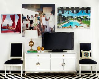 A living room with gallery wall, white console table and TV