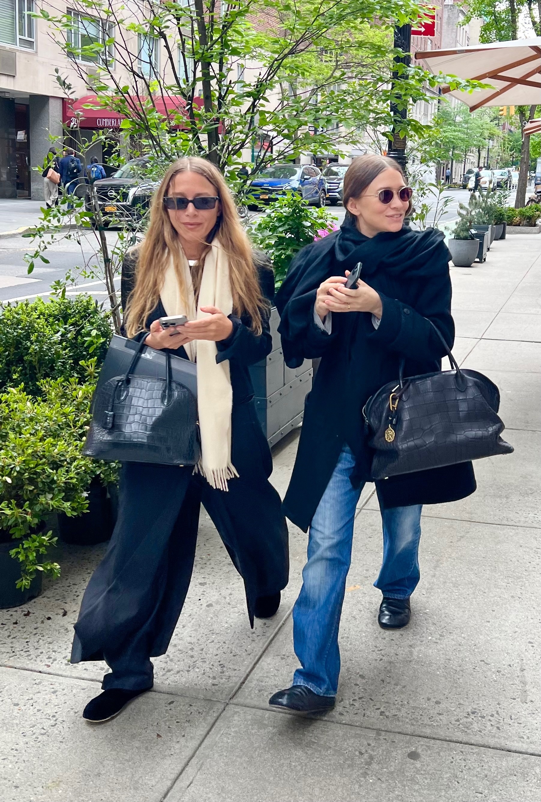 Mary-Kate and Ashley Olsen wearing croc-embossed bags.