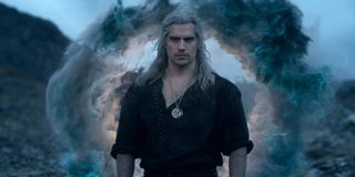 Geralt of Rivia stands in front of a portal