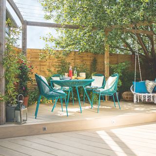 raised garden deck area with blue patio furniture