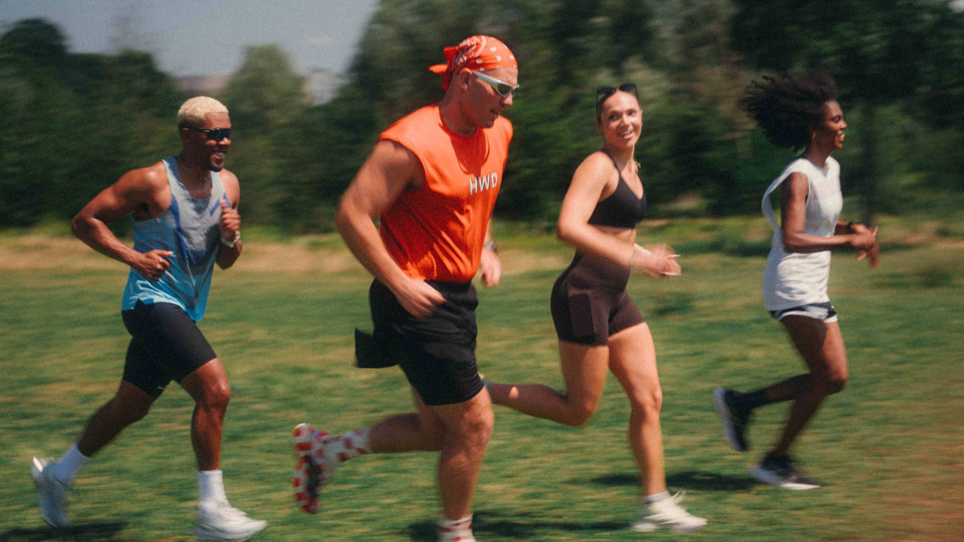 an image of four friends running together as part of the Team Marathon race