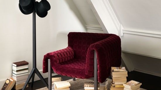 assymetrical velvet chair on designed floor