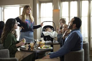 From left: MARIA PALLAS, KAITLIN OLSON, MATTHEW LAMB, AMIRAH JOHNSON, DANIEL SUNJATA, sitting and standing around a table at a restaurant in 'High Potential.'