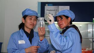 Scientists prepare samples for the German-Chinese SIMBOX science payload on Shenzhou 8