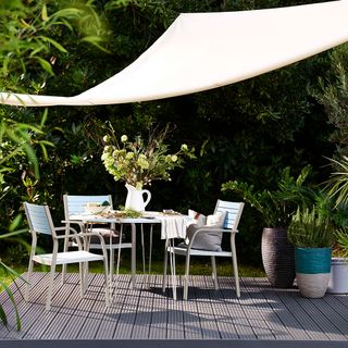 garden trees with decking and table and chairs