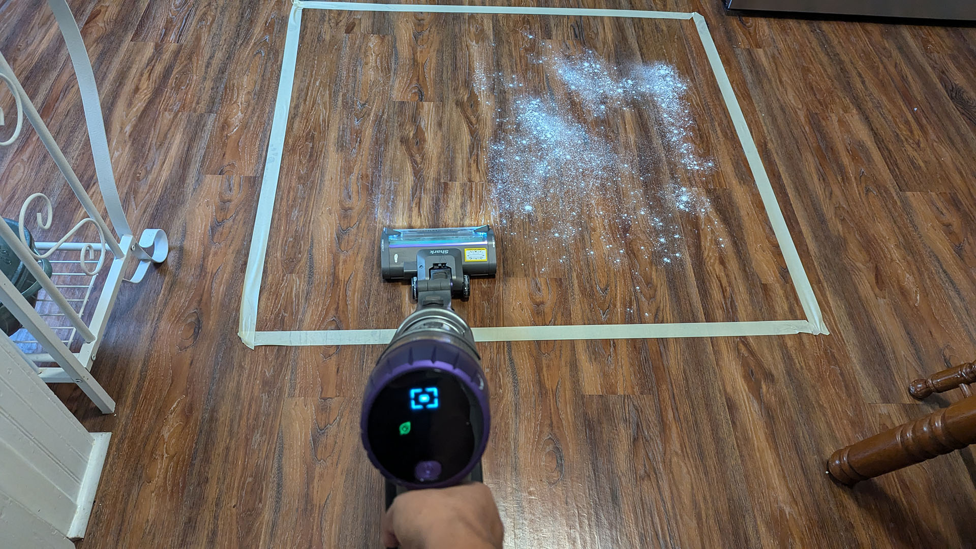 Shark PowerDetect Cordless vacuum cleaner trying to pick up flour from a laminate floor