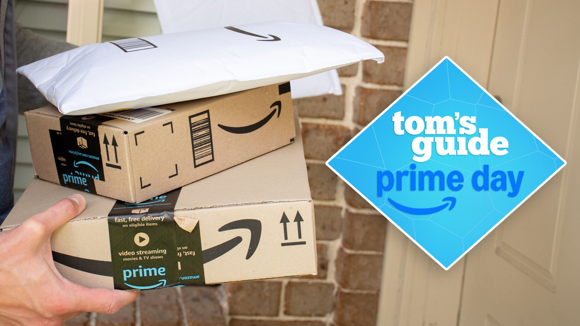 Person holding Amazon packages at their front door with 'Tom's Guide Prime Day' deal badge overlaid