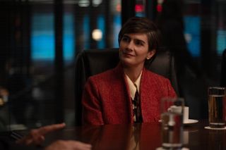 gaby hoffmann as monica wearing a red blazer sitting at a conference table in zero day