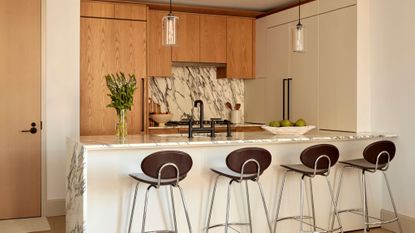 kitchen in light wood and marble backsplash