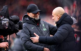 Jurgen Klopp and Pep Guardiola embrace on the touchline before kick off