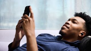 Man listening to audio on the Synseer earbuds