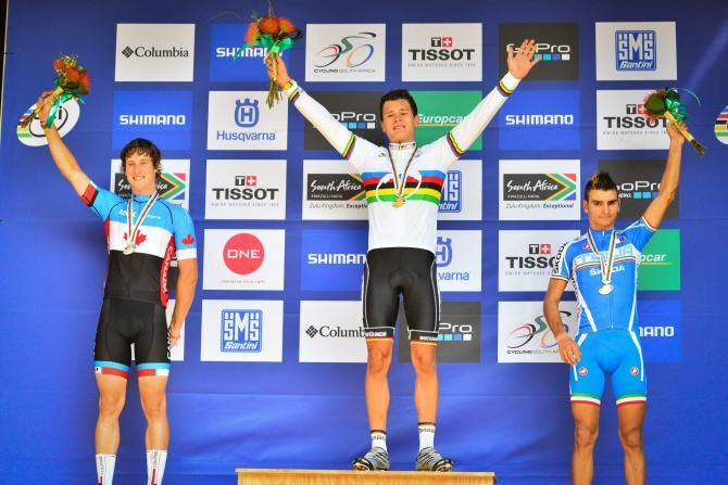 Lukas Baum of Germany (centre), flanked by Peter Disera of Canada (left) and Gioele Bertolini of Italy (right), sporting his newly awarded rainbow striped jersey