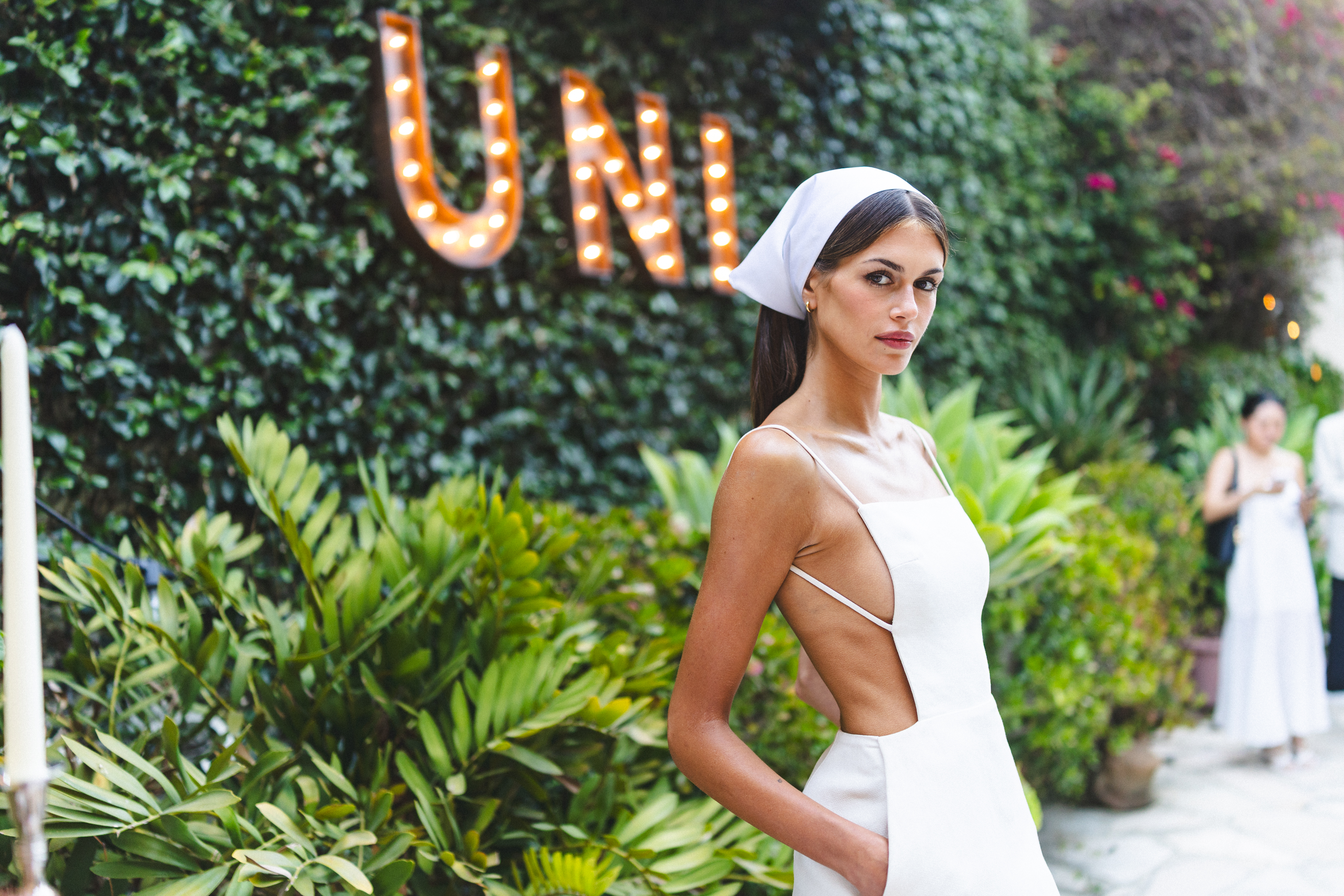 Kaia Gerber wears a little white dress with no sides from Calvin Klein Collection and square toe pumps to attend the Summer Uni Party on June 18, 2026 in Los Angeles, California