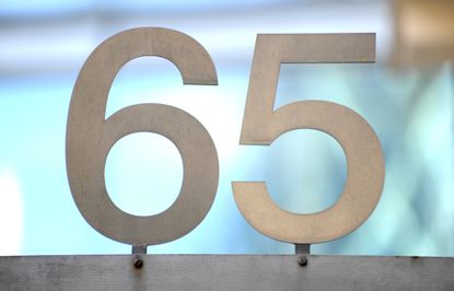 the number 65 in grey metallic against a light blue background