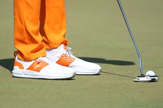 Close up photo of Rickie Fowler putting