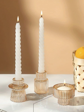 three ribbed glass candle holders on a table