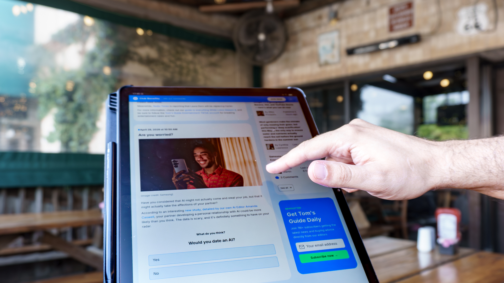 A person scrolling through the redesigned Tom's Guide home page on the TCL NXTPAPER 14