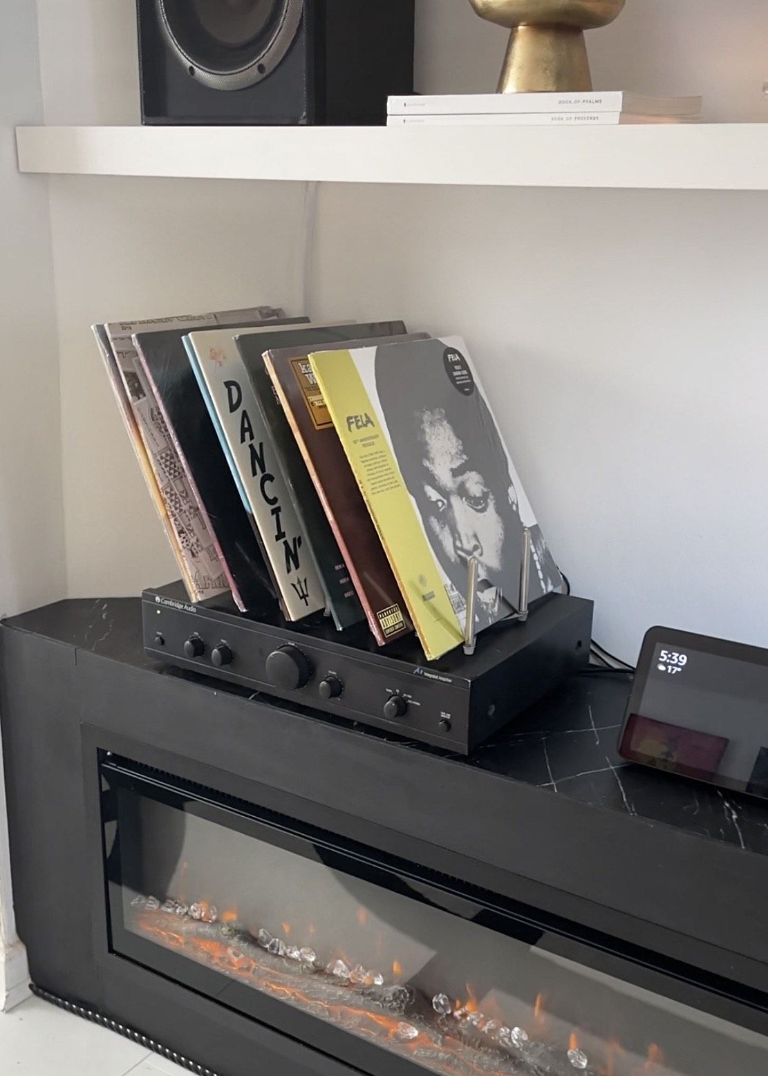 close up of records displayed on top of speaker on pot rack