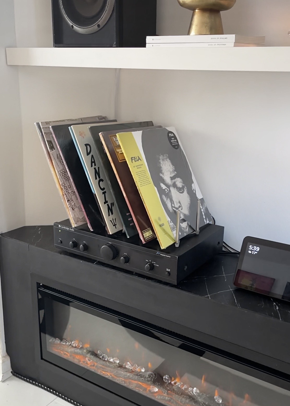 close up of records displayed on top of speaker on pot rack