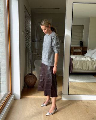 Fashion influencer Anouk Yve wearing an on-trend fall/winter 2024 outfit styled with a chic sweater.