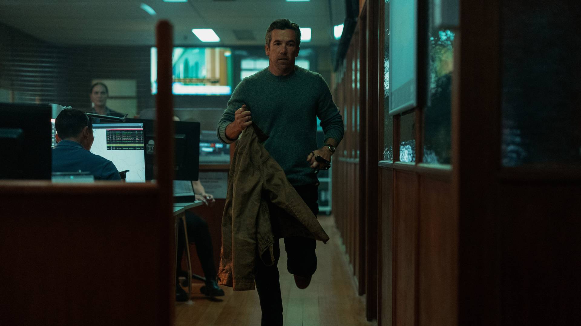 Patrick Brammall as Ian Ridley running through an office in Last Seen