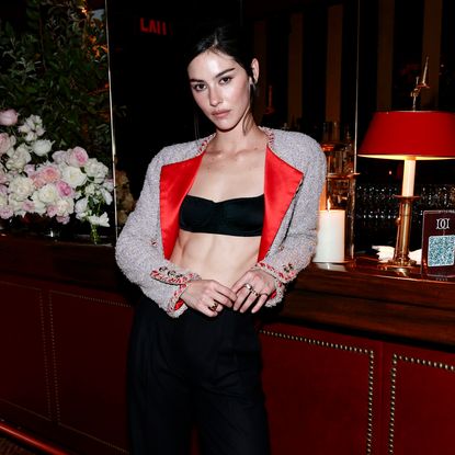Gracie Abrams wears a Chanel tuxedo jacket with a black bandeau
