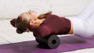 a woman working her back on a foam roller