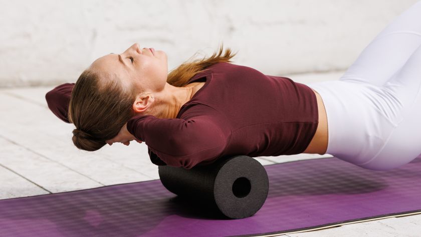 a woman working her back on a foam roller