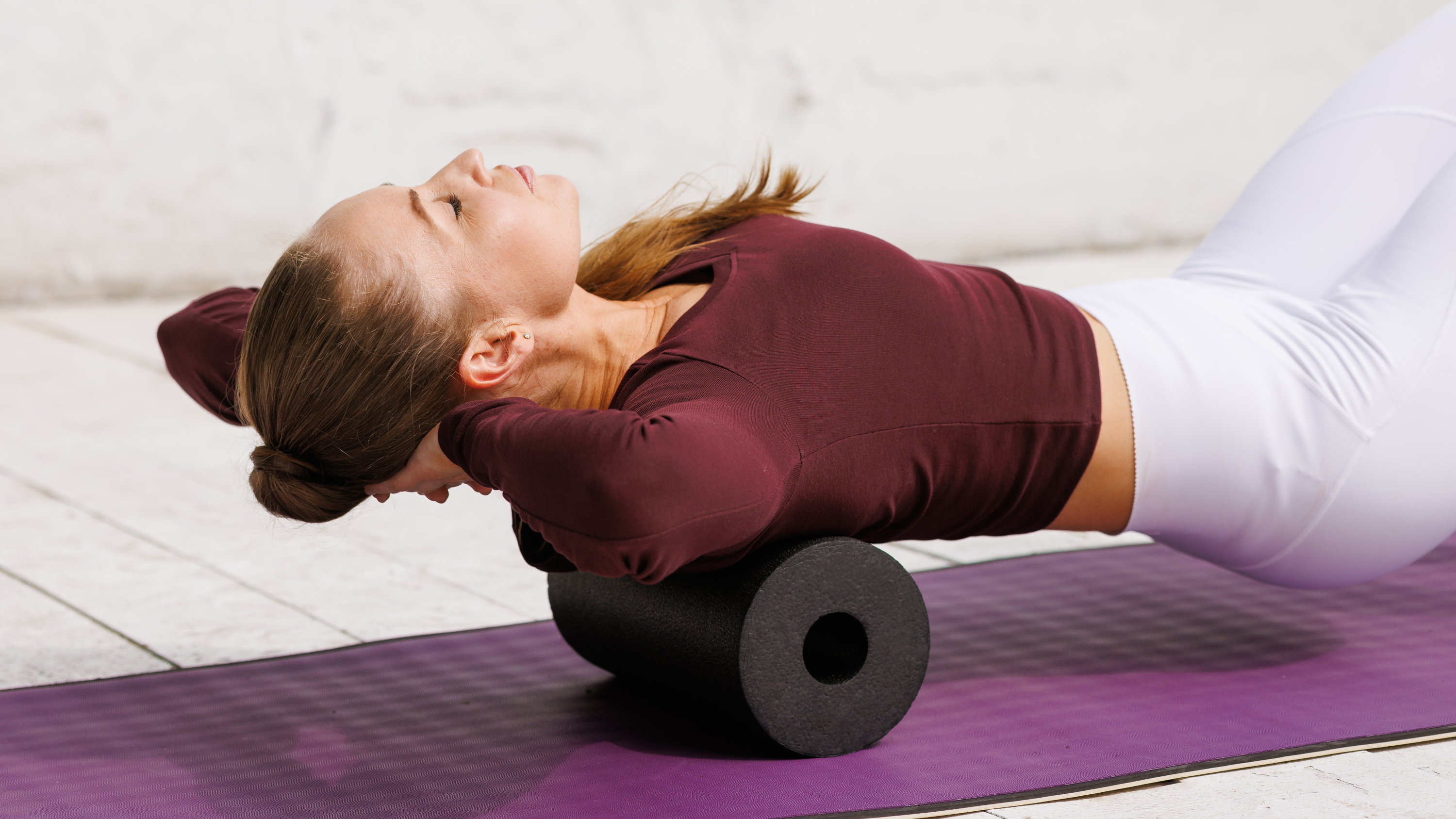 a woman working her back on a foam roller