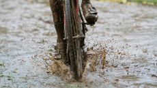 Cyclist riding through deep mud