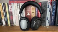 Bowers & Wilkins Px7 S3 in front of a bookshelf full of books