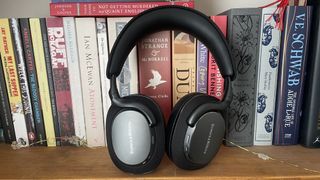 Bowers & Wilkins Px7 S3 in front of a bookshelf full of books