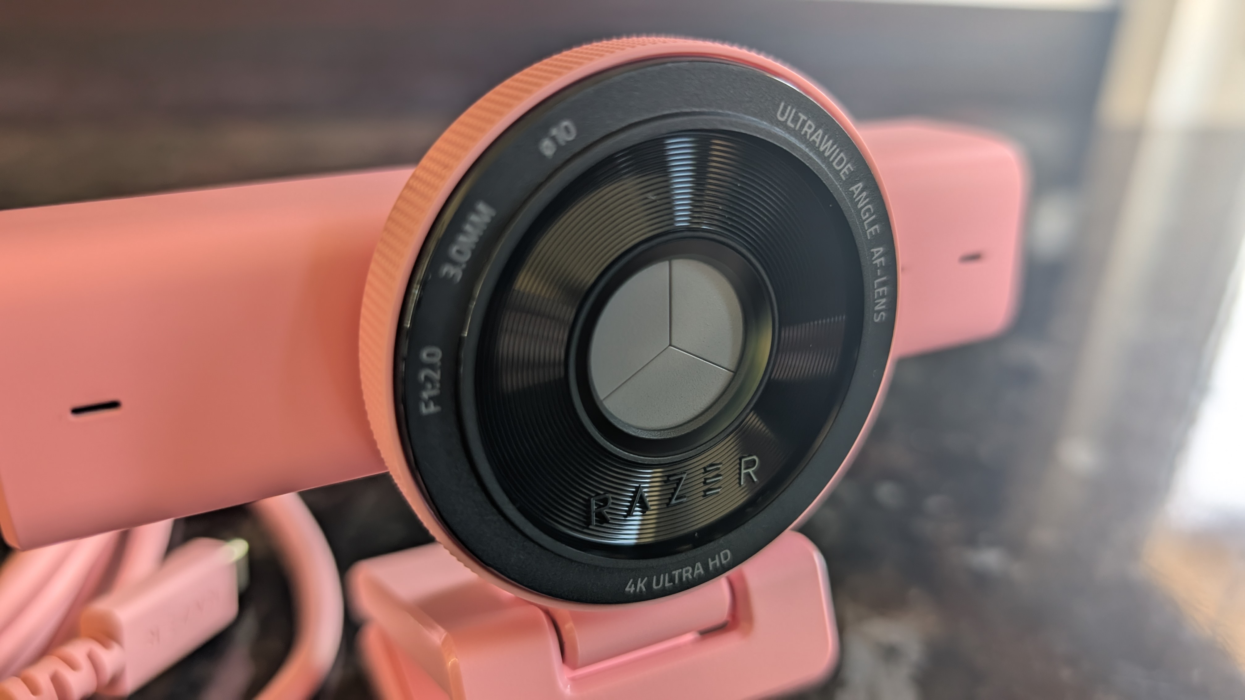 The Razer Kiyo V2 webcam pictured on a dark marble worksurface.
