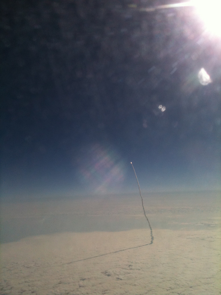 Airline passenger Stefanie Gordon used an iPhone to snap this photo of the space shuttle Endeavour streaking toward space on May 16. Gordon was flying from New York to Palm Beach, Fla., aboard a Delta jet.