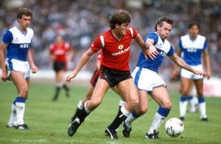 Manchester United's Norman Whiteside competes for the ball with Everton's Peter Reid in the 1985 Charity Shield.