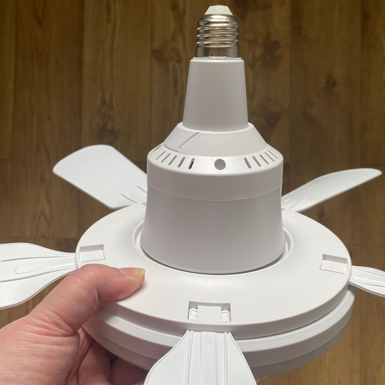 Holding the Amazon ceiling fan and showing the connector on the base