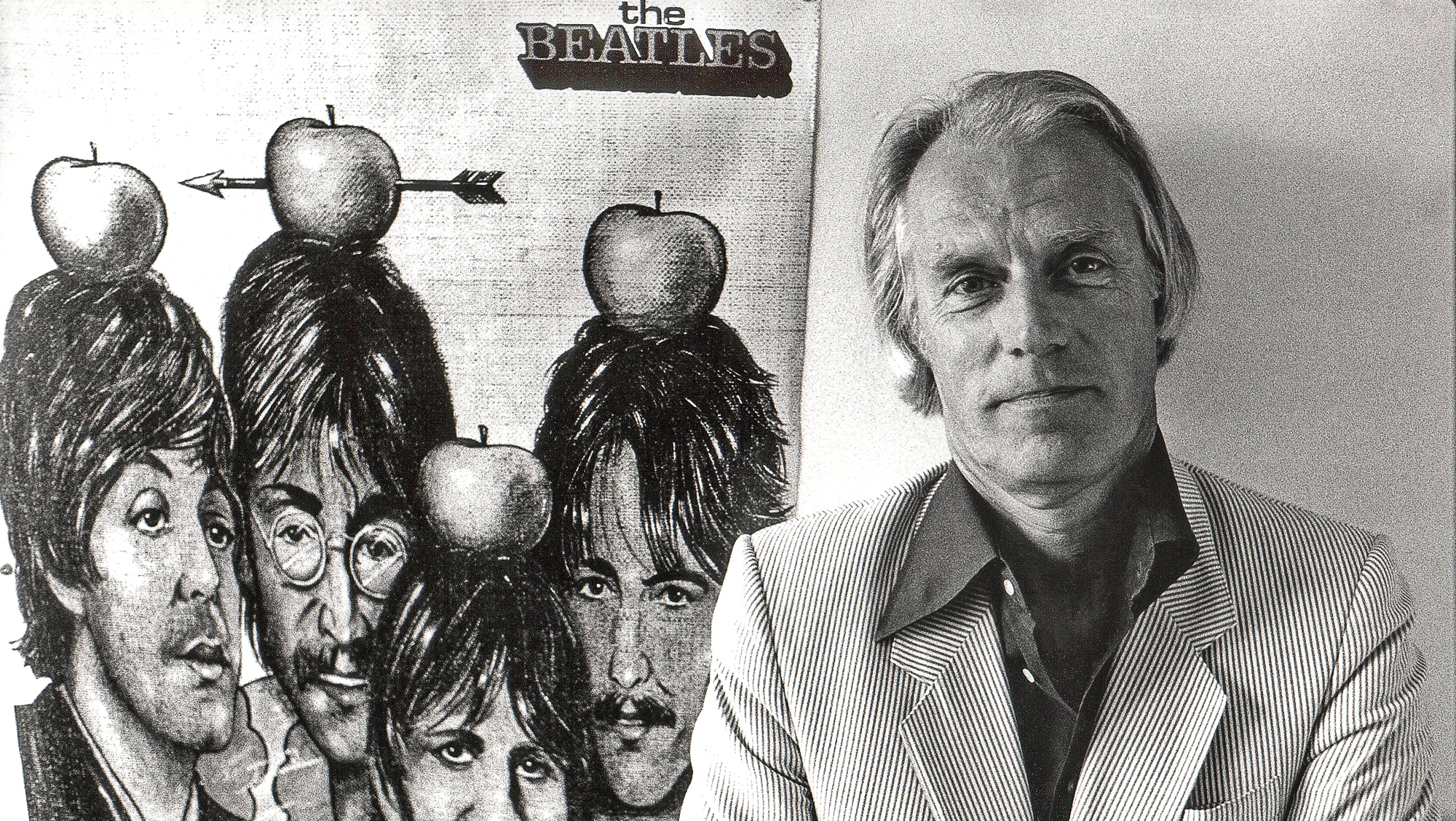 Producer George Martin stands next to a drawing of the Beatles, the English pop group he produced and led to success, in June 1984
