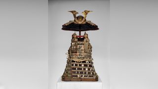 An ornate suit of Japanese armor decorated with gold