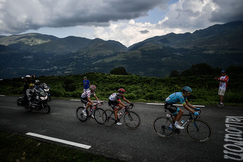 Tanel Kangert (R), Croatia's Kristijan Durasek (C) and France's Julian Alaphilippe, wearing the best climber's polka dot jersey, ride during a breakaway in the first pass of the 17th stage