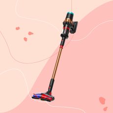 Dyson V16 Piston Animal vacuum on a pink background