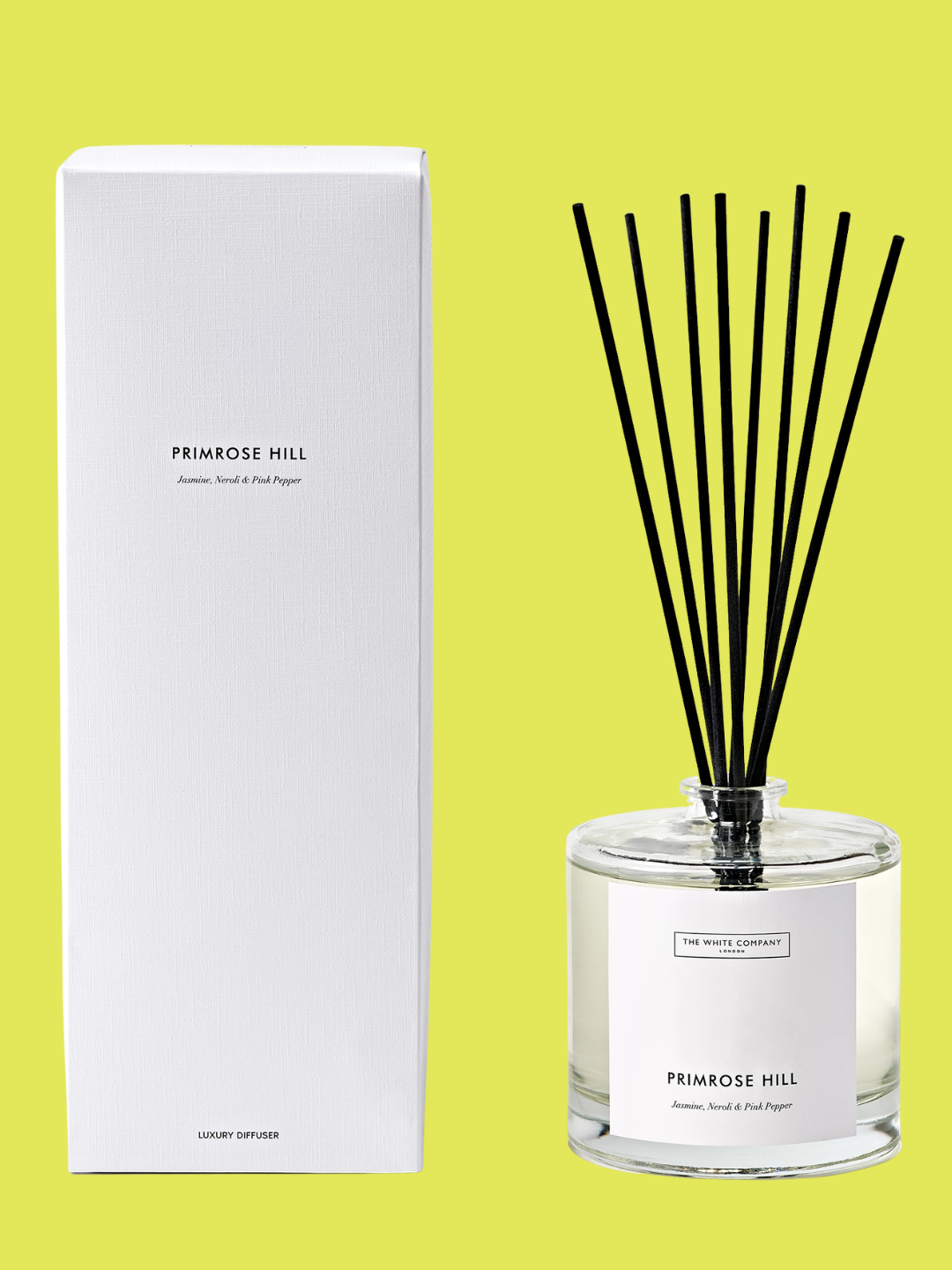 A glass vessel with black reeds from The White Company